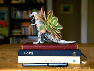 Photo of a dinosaur planter painted silver handmade gift