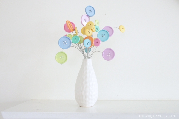 gorgeous button flower bouquet in a white vase photo